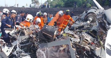 Rescuers inspect the crash site after two military helicopters collided in Lumut, Perak state, Malaysia, April 23, 2024. (AFP Photo)