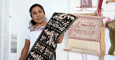 Hnahnu Indigenous woman Trinidad Gonzalez, from the Otomi area, explains the embroidery of the garment called &quot;Quexquemeth&quot; in the town of El Mejay in Hidalgo State, Mexico, April 10, 2024. (AFP Photo)