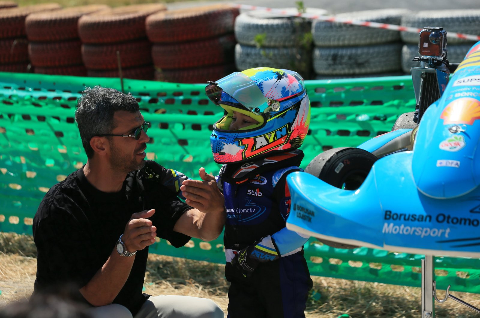 Kenan Sofuoğlu (L) instructs his son Zayn Sofuoğlu during the Türkiye Karting Championship, Kocaeli, Türkiye, April 21, 2024. (AA Photo)