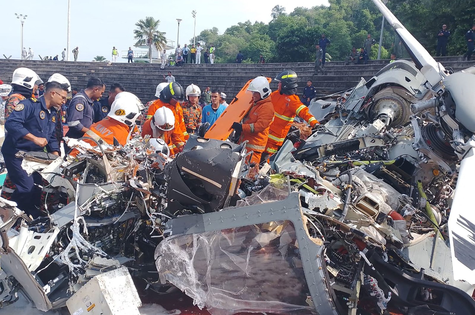 Rescuers inspect the crash site after two military helicopters collided in Lumut, Perak state, Malaysia, April 23, 2024. (AFP Photo)