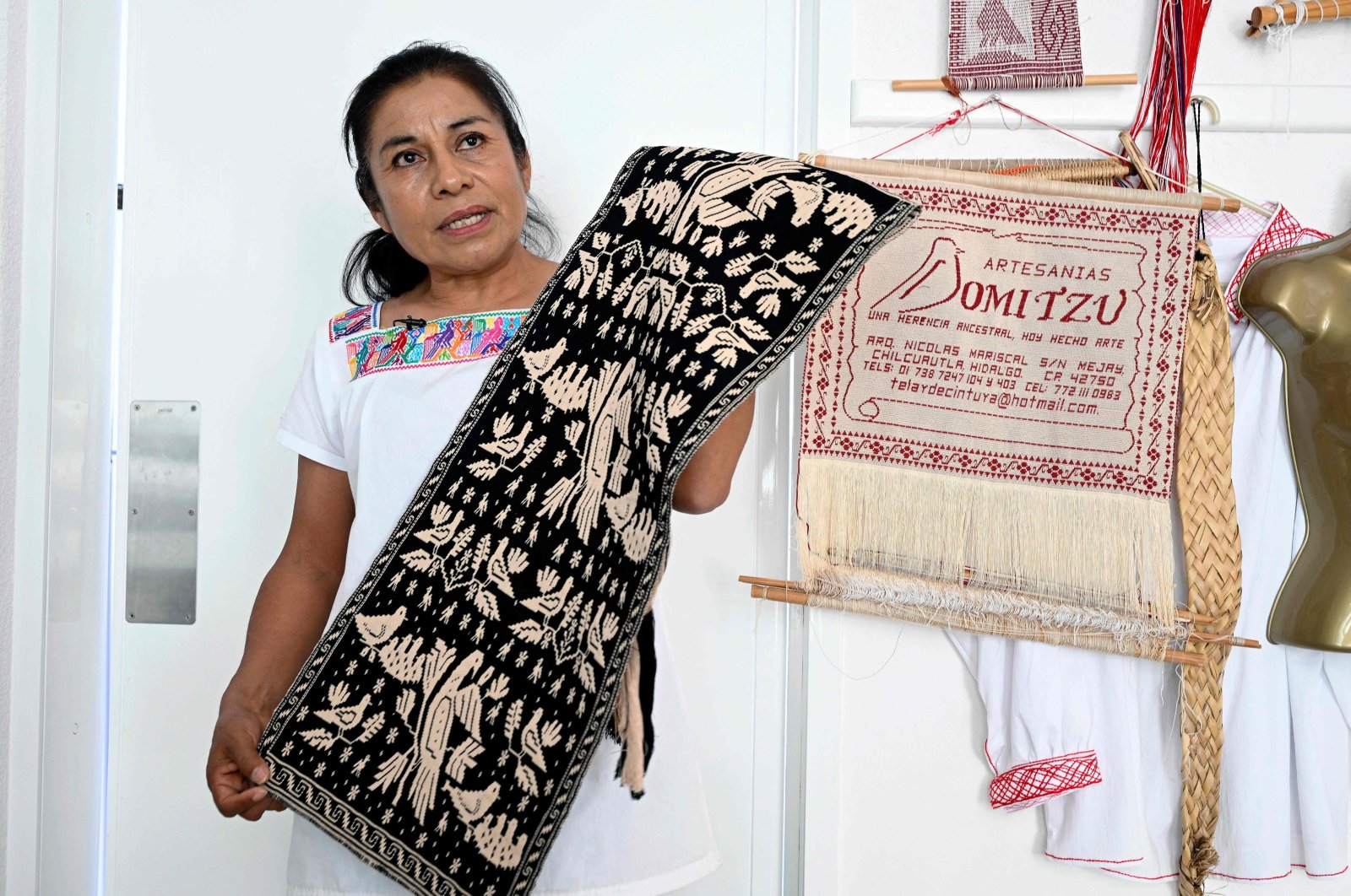 Hnahnu Indigenous woman Trinidad Gonzalez, from the Otomi area, explains the embroidery of the garment called &quot;Quexquemeth&quot; in the town of El Mejay in Hidalgo State, Mexico, April 10, 2024. (AFP Photo)