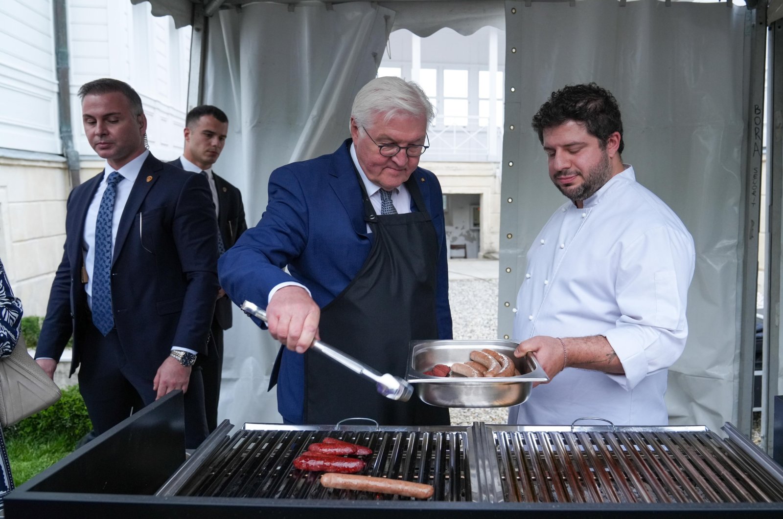 German President Frank-Walter Steinmeier cooks sausages for guests at an event in Istanbul, Türkiye, April 22, 2024. (AA Photo)