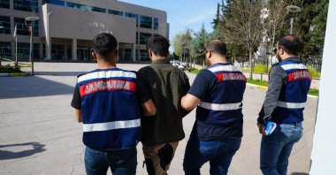 Gendarmerie officers escort to the courthouse a wanted PKK terrorist caught in a raid in southeastern Kilis province, Türkiye, April 3, 2024. (IHA Photo)