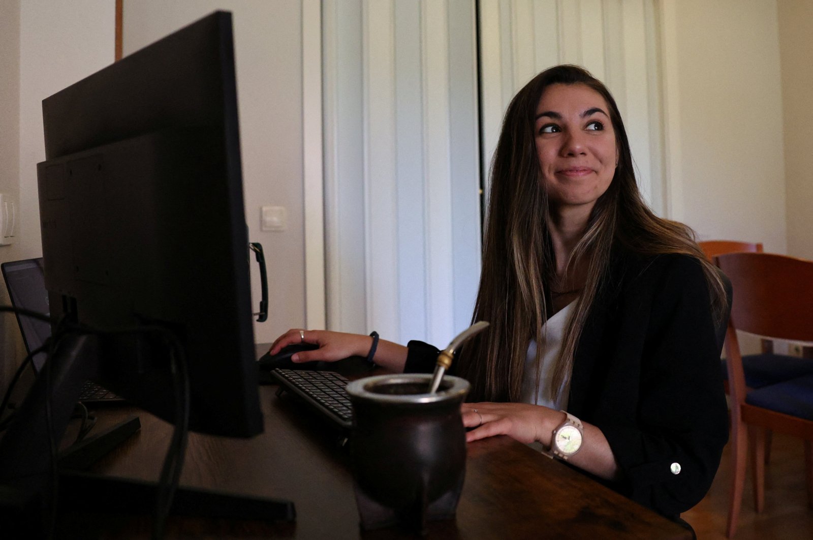 Argentinian postdoctoral researcher in distributed systems Marianela Morales poses for a portrait at her work station in her Madrid home, Spain, April 19, 2024. (Reuters Photo)