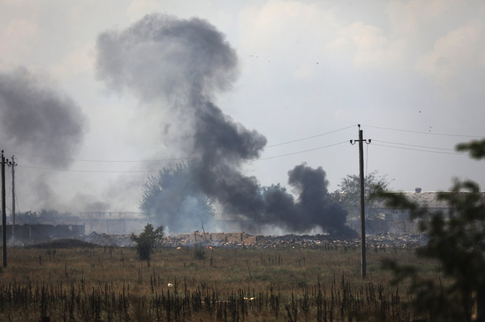 Smoke rises over the site of an explosion at an ammunition storage of the Russian army near the village of Mayskoye, Crimea, Tuesday, Aug. 16, 2022.  (AP File Photo)