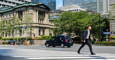 A pedestrian walks past the Bank of Japan (BOJ) building in central Tokyo, Japan, April 25, 2024. (AFP Photo)