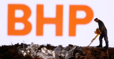  A small toy figure and mineral imitation are seen in front of the BHP logo in this illustration taken Nov. 19, 2021. (Reuters Photo)
