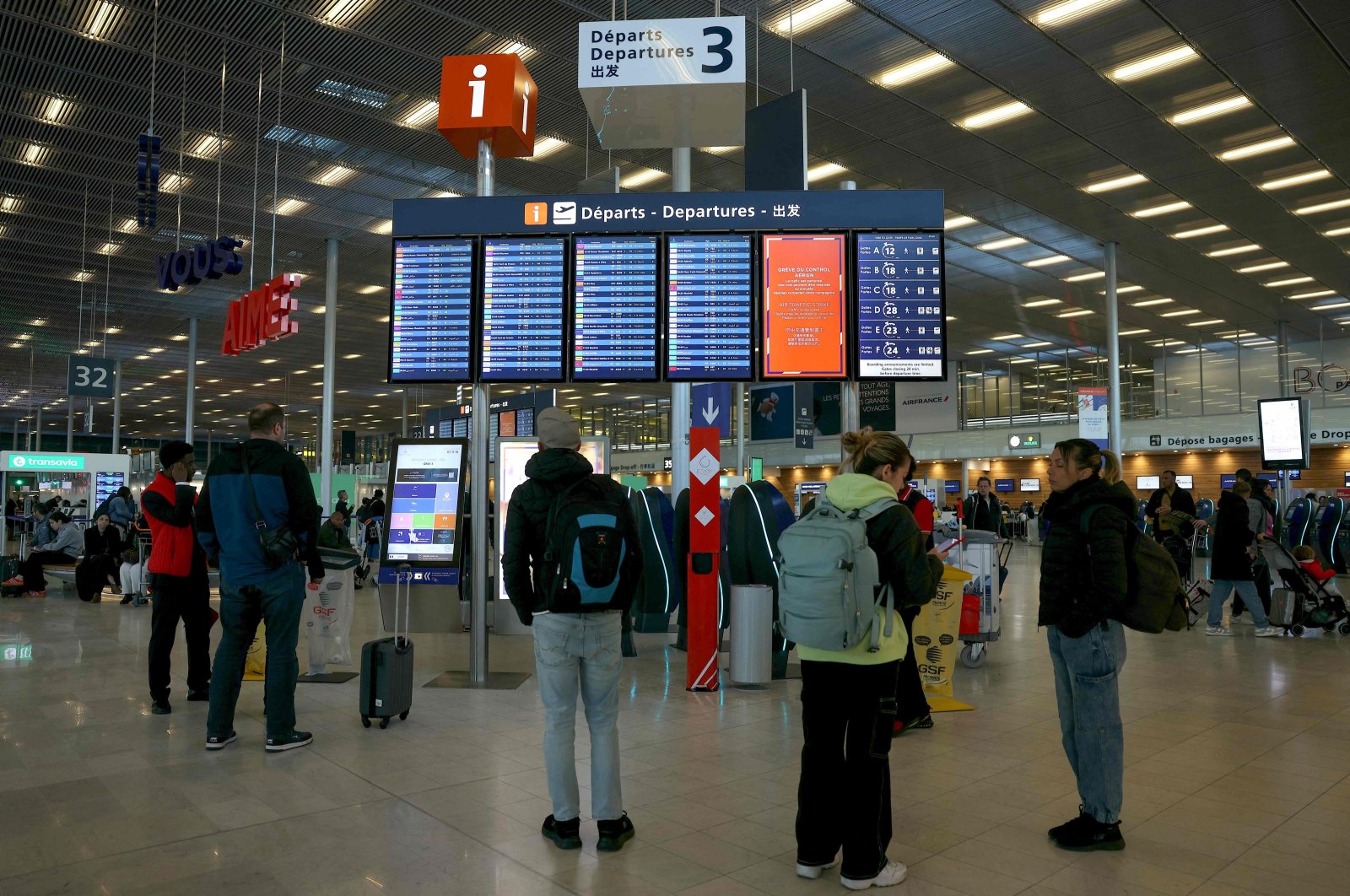 Passengers look at the flight board where many flights were canceled due to a strike, Orly airport, outside Paris, France, April 25, 2024. (AFP Photo)
