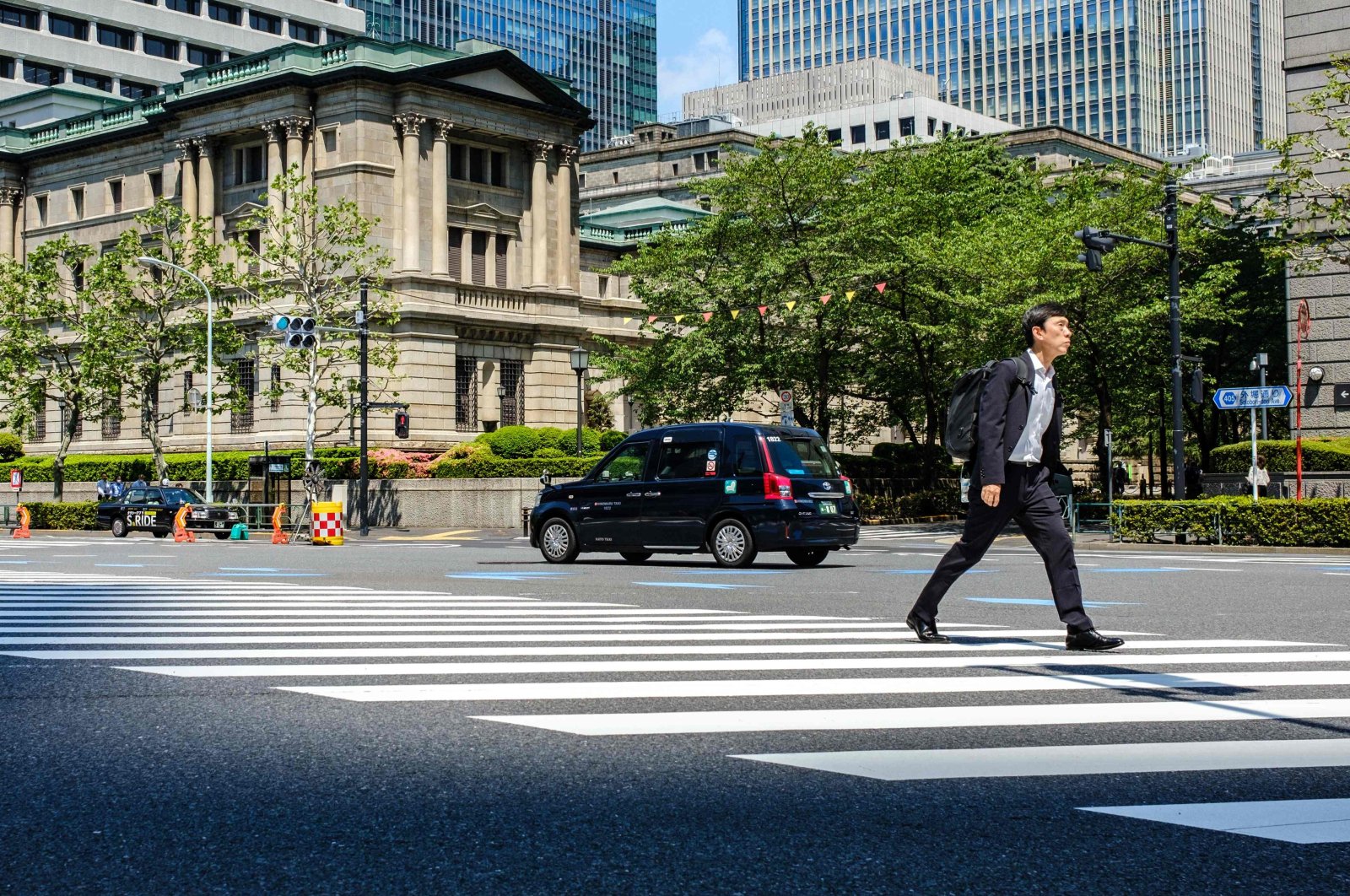 A pedestrian walks past the Bank of Japan (BOJ) building in central Tokyo, Japan, April 25, 2024. (AFP Photo)