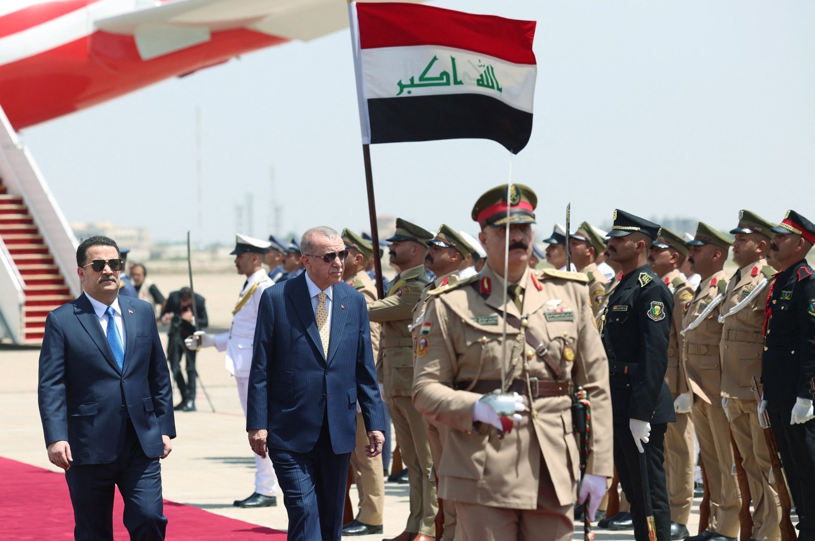 Iraq&#039;s Prime Minister Mohammed S. Al Sudani (L) welcomes President Recep Tayyip Erdoğan (C) upon his arrival at the Baghdad International Airport at the start of his official visit, Baghdad, Iraq, April 22, 2024. (AFP Photo)