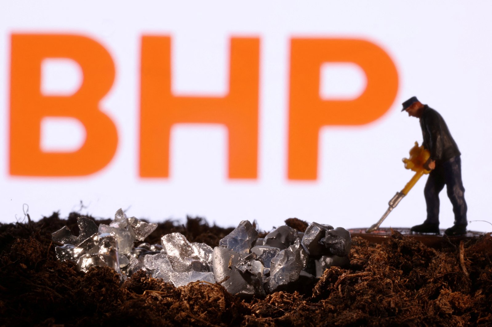  A small toy figure and mineral imitation are seen in front of the BHP logo in this illustration taken Nov. 19, 2021. (Reuters Photo)