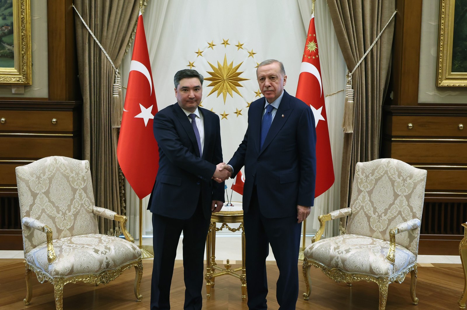 President Recep Tayyip Erdoğan and Kazakh Prime Minister Olzhas Bektenov shake hands in Türkiye&#039;s capital Ankara, April 25, 2024. (DHA Photo)