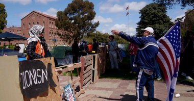 A pro-Palestinian demonstrator interacts with a pro-Israel demonstrator in an encampment on the campus of UCLA in Los Angeles, California, U.S., April 25, 2024. (AFP Photo)