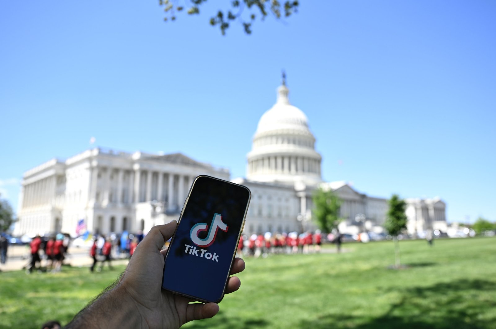 The TikTok app logo is seen on a smartphone in front of the U.S. Capitol building, Washington, U.S., April 20, 2024. (AA Photo)