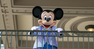An actor dressed as Mickey Mouse greets visitors at the entrance to Magic Kingdom Park at Walt Disney World Resort, Florida, U.S., April 18, 2022. (AP Photo)