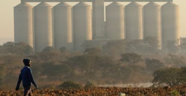 A boy walks along a prepared field in front of grain silos in the farming area of Chinhoyi, Zimbabwe, July 26, 2017. (Reuters Photo)