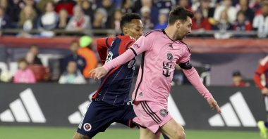 New England Revolution midfielder Mark-Anthony Kaye (L) and Inter Miami forward Lionel Messi chase the ball in the first half of an MLS match, Foxborough, U.S., April 27, 2024. (AP Photo)