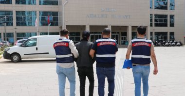 Gendarmerie officers accompany a caught PKK suspect in Kilis, southeastern Türkiye, April 27, 2024. (AA Photo)