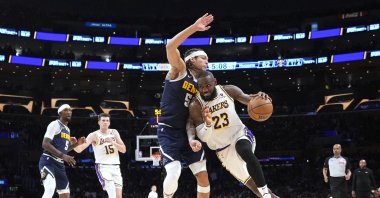 Los Angeles Lakers forward LeBron James (R) drives past Denver Nuggets forward Aaron Gordon during the second half in Game 4 of an NBA basketball first-round playoff series, Los Angeles, U.S., April 27, 2024. (AP Photo)