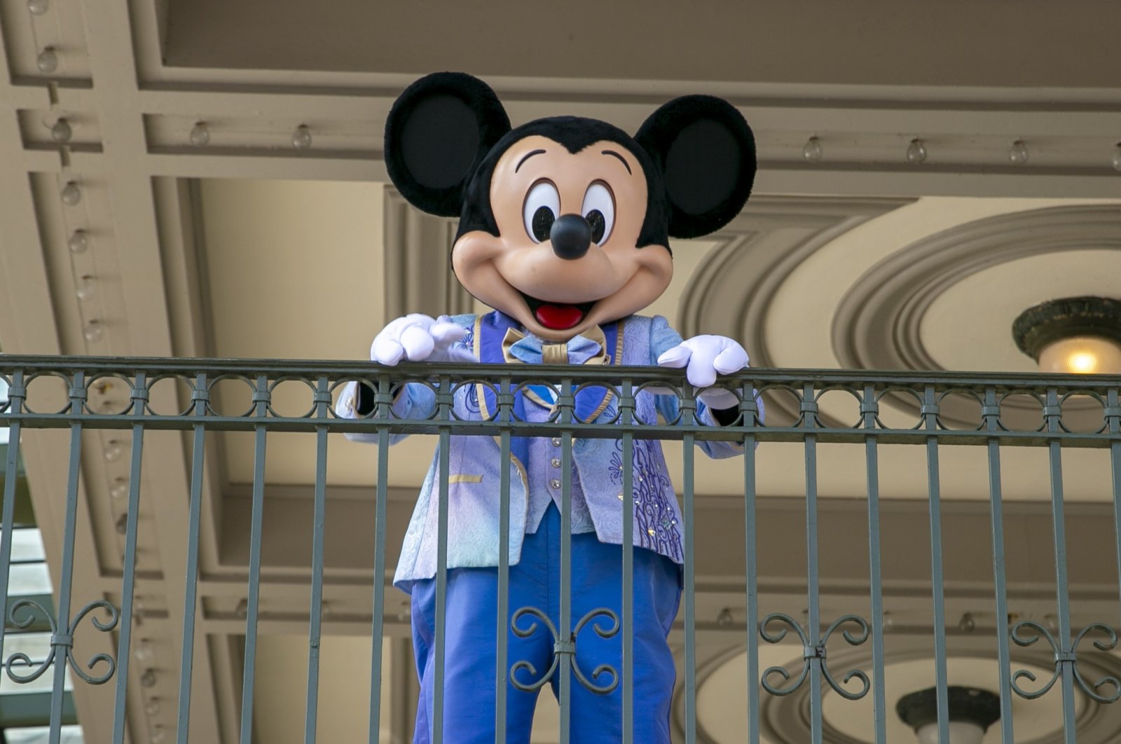 An actor dressed as Mickey Mouse greets visitors at the entrance to Magic Kingdom Park at Walt Disney World Resort, Florida, U.S., April 18, 2022. (AP Photo)