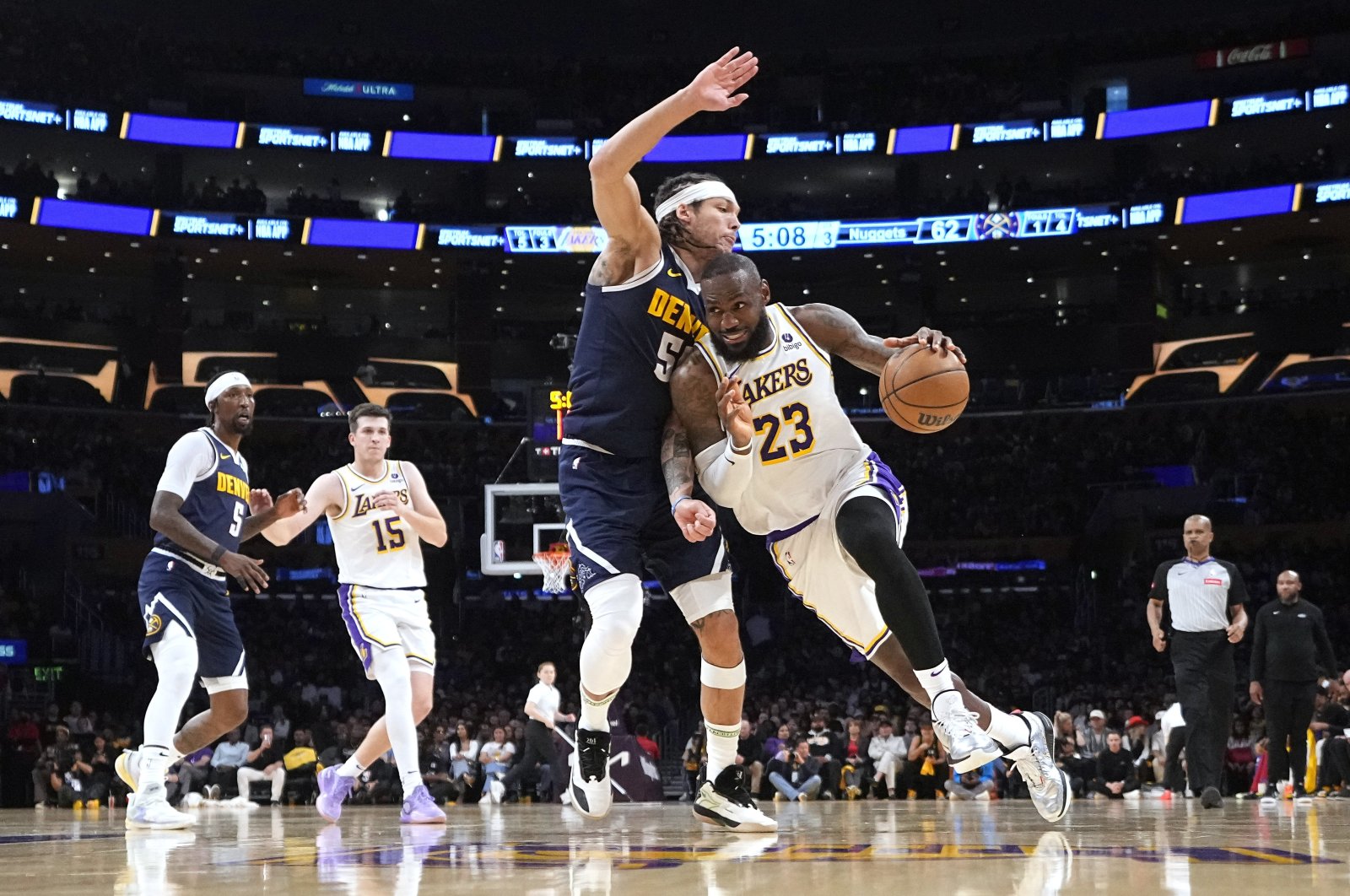 Los Angeles Lakers forward LeBron James (R) drives past Denver Nuggets forward Aaron Gordon during the second half in Game 4 of an NBA basketball first-round playoff series, Los Angeles, U.S., April 27, 2024. (AP Photo)