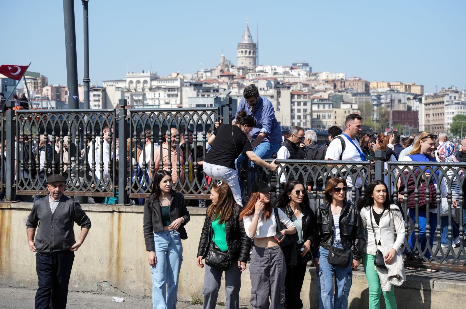 People are photographed with the backdrop of Galata Tower, Istanbul, Türkiye, April 12, 2024. (IHA Photo)