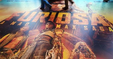Attendees walk over a floor advertisement for the upcoming film "Furiosa: A Mad Max Saga" on the opening day of CinemaCon 2024, Caesars Palace, Las Vegas, Nevada, U.S., April 8, 2024. (AP Photo)