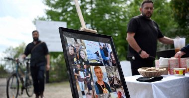 A set of photographs of Damian Sobol, a member of the U.S.-based food charity World Central Kitchen, killed in an Israeli strike in Gaza, is seen during his funeral ceremony at the cemetery in his hometown of Przemysl, Poland, April 20, 2024. (AFP Photo)