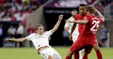 Real Madrid's Luka Modric (L) slides as he goes for the ball against Bayern Munich players during the first half of an International Champions Cup match, Houston, U.S., July 20, 2019. (AP Photo)