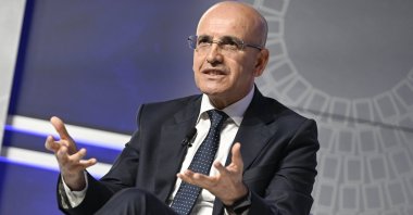Treasury and Finance Minister Mehmet Şimşek speaks during an event on the sidelines of the International Monetary Fund/World Bank spring meetings, Washington, U.S., April 18, 2024. (AA Photo)