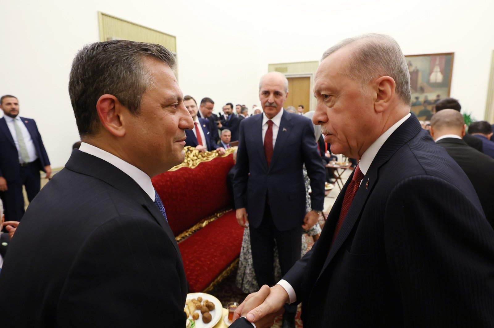 President Recep Tayyip Erdoğan (R) shakes hands with Republican People&#039;s Party (CHP) Chair Özgür Özel (L) as they attend a public holiday reception hosted by Parliament Speaker Numan Kurtulmuş (C), Ankara, Türkiye, April 23, 2024. (AA Photo)