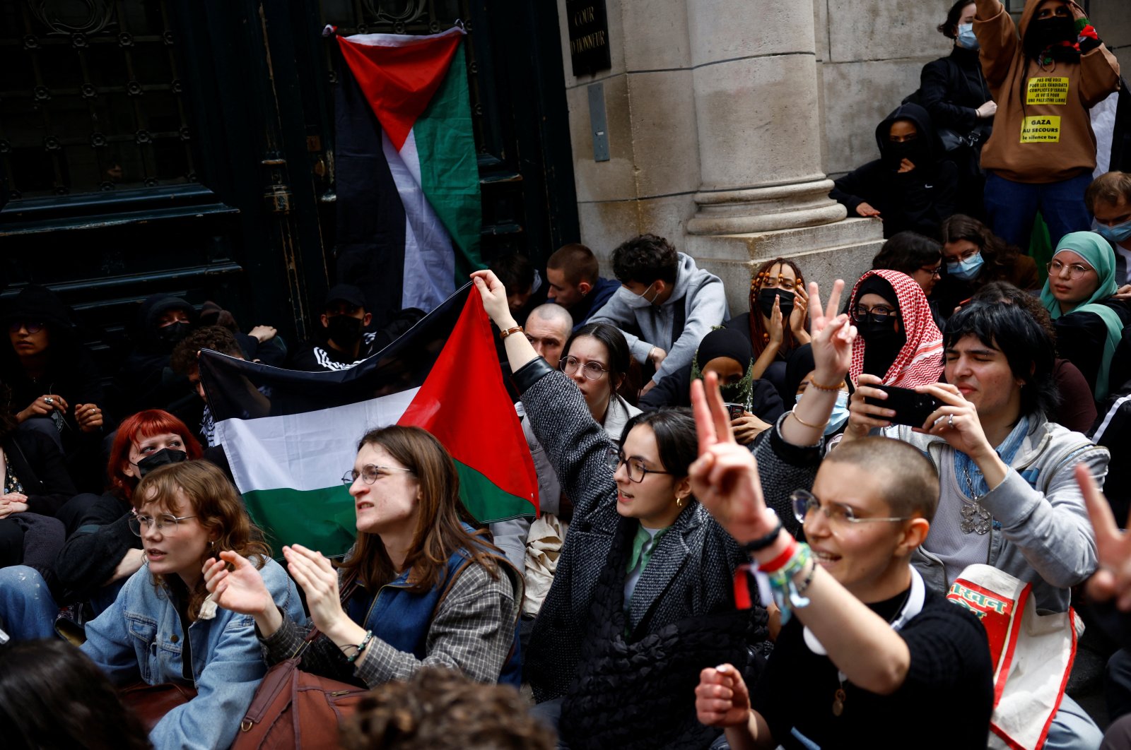 Students hold Palestinian flags as they block the entrance of the Sorbonne University in support of Palestinians in Gaza, Paris, France, April 29, 2024. (Reuters Photo)
