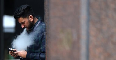 A person vapes in London, Britain, April 16, 2024. (Reuters Photo)