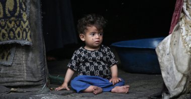 A Palestinian child sits at the entrance of a tent in Rafah, in the southern Gaza Strip, Palestine, April 30, 2024. (AFP Photo)