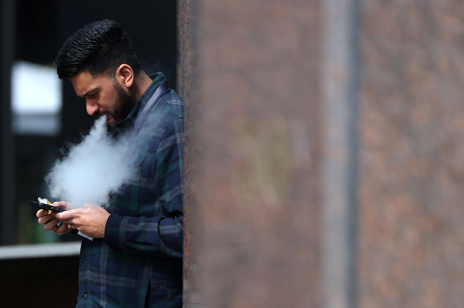 A person vapes in London, Britain, April 16, 2024. (Reuters Photo)