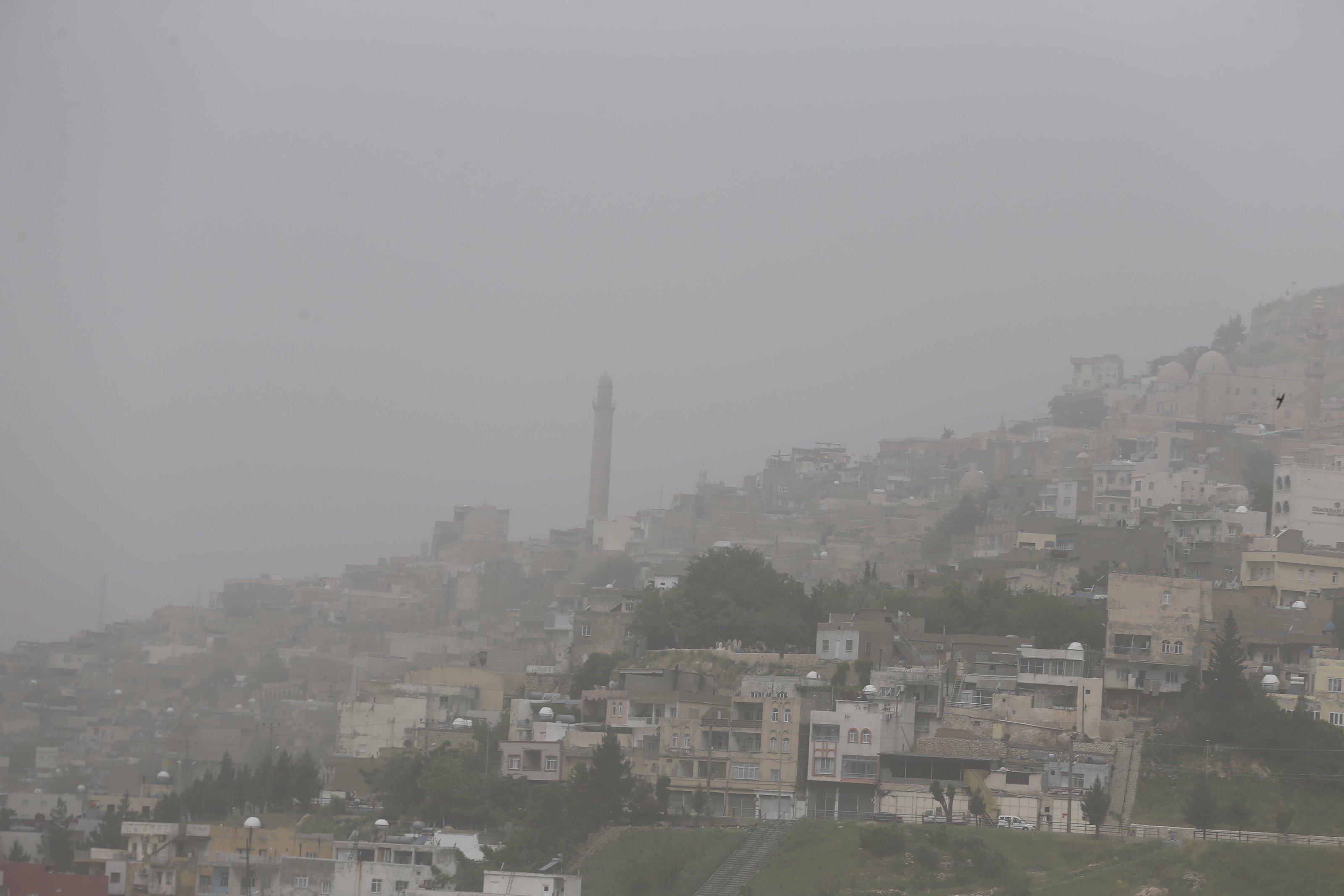 Dust storm reduces visibility in the city and covers buildings, vehicles and houses with dust, Mardin, Türkiye. April 30, 2024. (AA Photo)