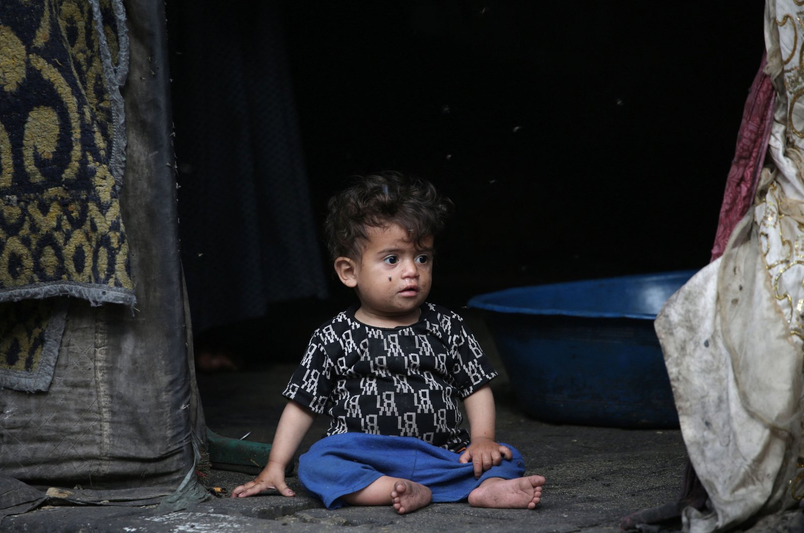 A Palestinian child sits at the entrance of a tent in Rafah, in the southern Gaza Strip, Palestine, April 30, 2024. (AFP Photo)