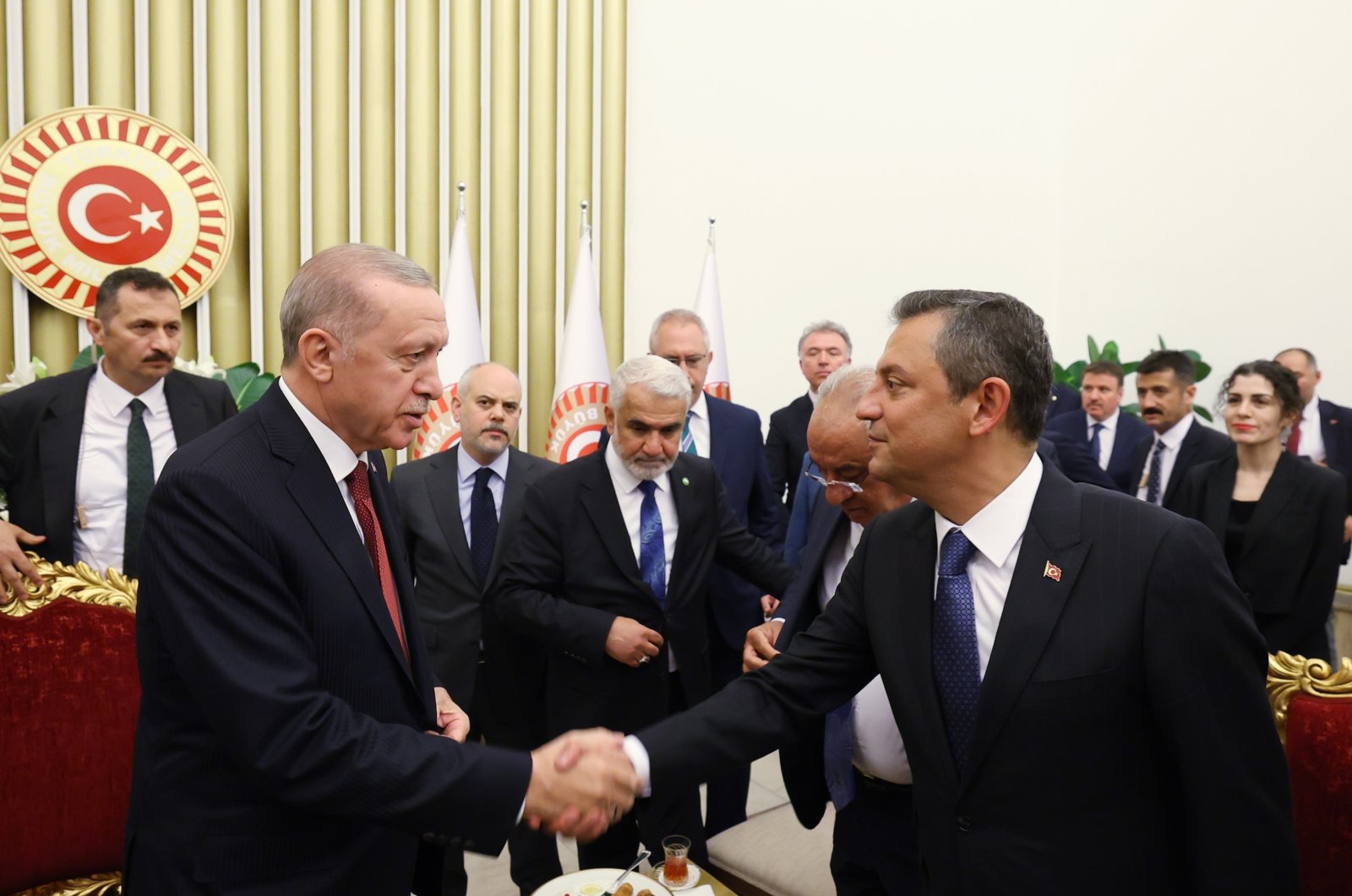President Recep Tayyip Erdoğan and CHP Chairman Özgür Özel shake hands at the April 23 reception in Ankara, April 23, 2024. (IHA Photo)