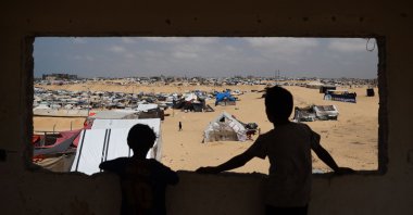 Palestinian children stand in a camp for displaced people in Rafah in the southern Gaza Strip by the border with Egypt, Palestine, April 28, 2024, (AFP Photo)