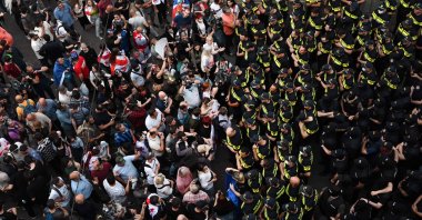 Demonstrators face police officers outside the Georgian parliament during a rally against the &quot;foreign influence&quot; bill, in Tbilisi on May 1, 2024. (AFP Photo)