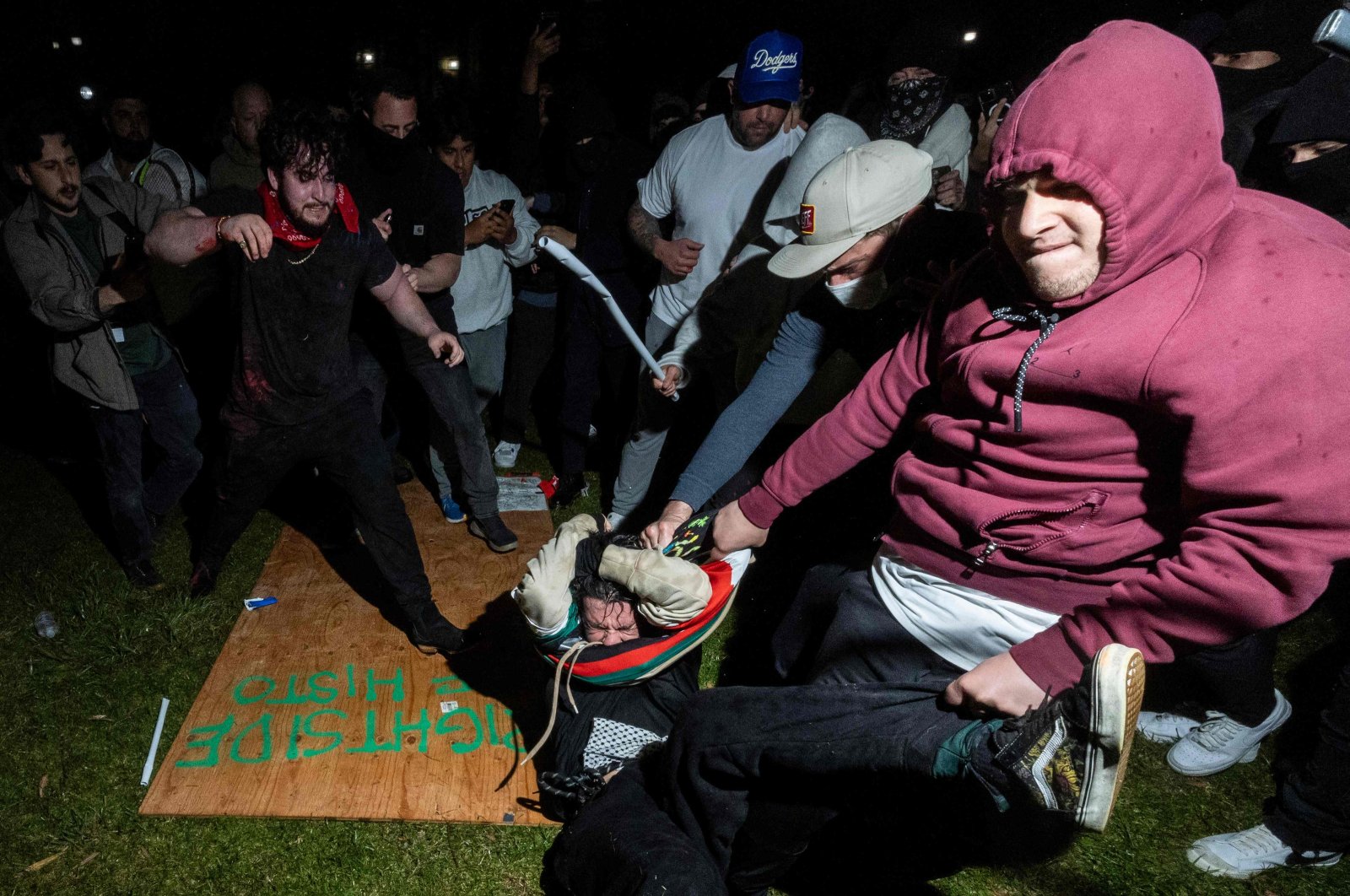 A pro-Palestinian demonstrator (C) is beaten by counterprotesters attacking a pro-Palestinian encampment on University of California Los Angeles (UCLA) campus, in Los Angeles, U.S., May 1, 2024. (AFP Photo)