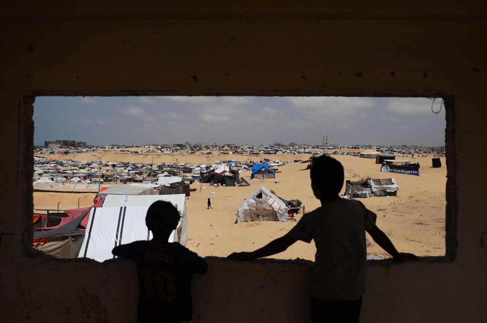 Palestinian children stand in a camp for displaced people in Rafah in the southern Gaza Strip by the border with Egypt, Palestine, April 28, 2024, (AFP Photo)