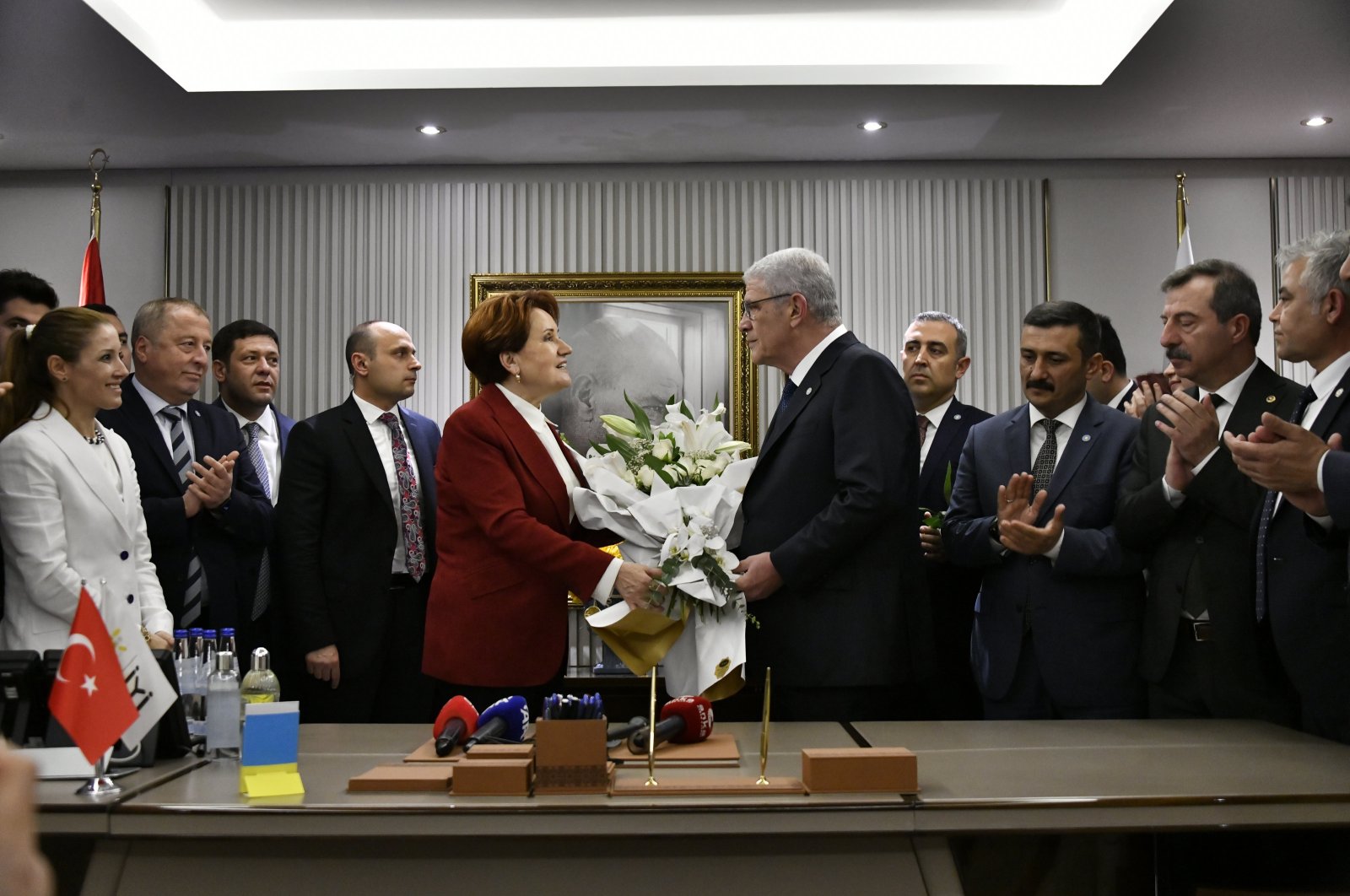 Former Good Party (IP) Chairperson Meral Akşener (L) presents flowers to her successor Müsavat Dervişoğlu at the handover ceremony in the capital Ankara, Türkiye, May 1, 2024. (AA Photo)