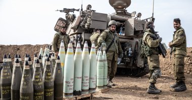 Israeli soldiers stand next to crates of internationally banned phosphorus bombs used in the Gaza Strip, Palestine, Oct. 9, 2023. (AA Photo)