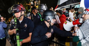 Police react while pro-Palestinian students stand their ground after police breached their encampment at the campus of the University of California, Los Angeles (UCLA) in Los Angeles, California, May 2, 2024. (AFP Photos)