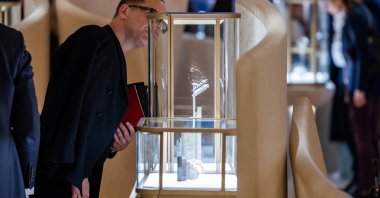A visitor looks at watch models at the Cartier booth at the Watches and Wonders exhibition in Geneva, Switzerland, April 9, 2024. (Reuters Photo)