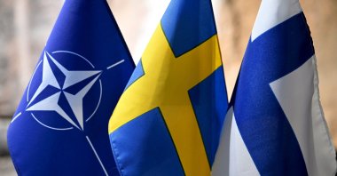 From left, flags of NATO, Sweden and Finland at the event &quot;Finland, Sweden, and Ukraine in an Expanded EU&quot; arranged by Swedish-Finnish Cultural Centre in Espoo, Finland, on March 26, 2024. (Reuters File Photo)