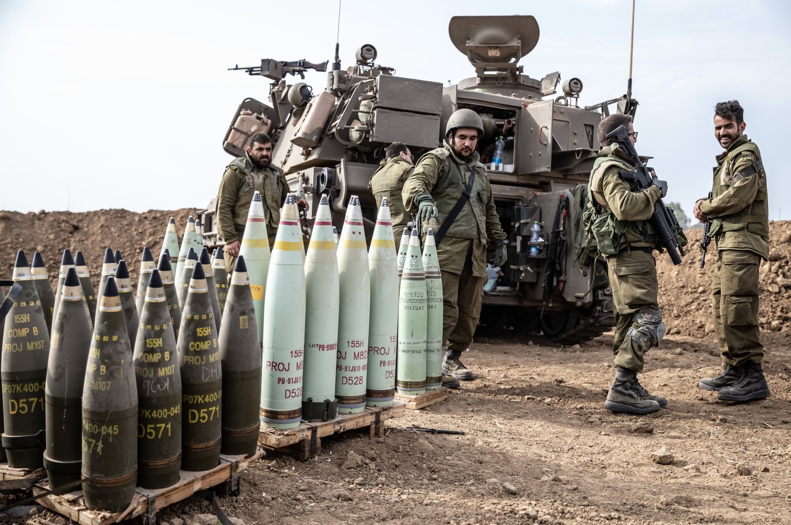 Israeli soldiers stand next to crates of internationally banned phosphorus bombs used in the Gaza Strip, Palestine, Oct. 9, 2023. (AA Photo)