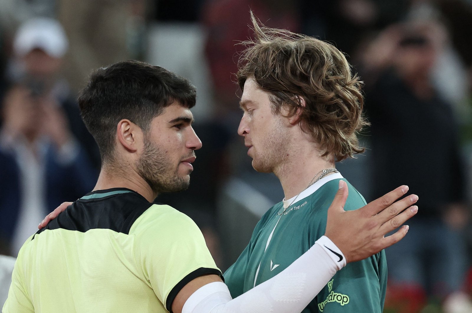 Russia&#039;s Andrey Rublev (R) greets Spain&#039;s Carlos Alcaraz after winning a 2024 ATP Tour Madrid Open tournament quarterfinals match, Caja Magica, Madrid, Spain, May 1, 2024. (AFP Photo)