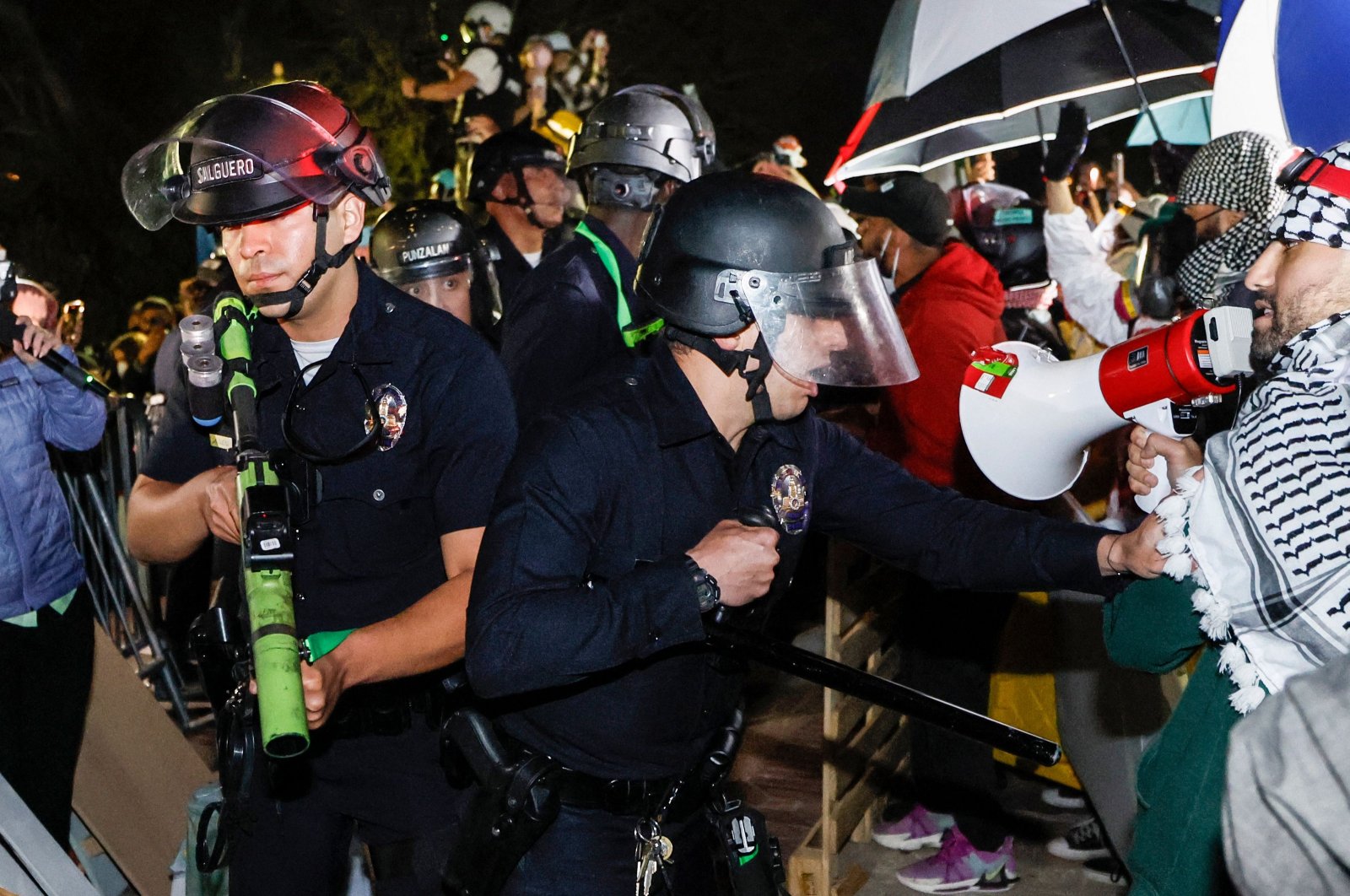 Police react while pro-Palestinian students stand their ground after police breached their encampment at the campus of the University of California, Los Angeles (UCLA) in Los Angeles, California, May 2, 2024. (AFP Photos)